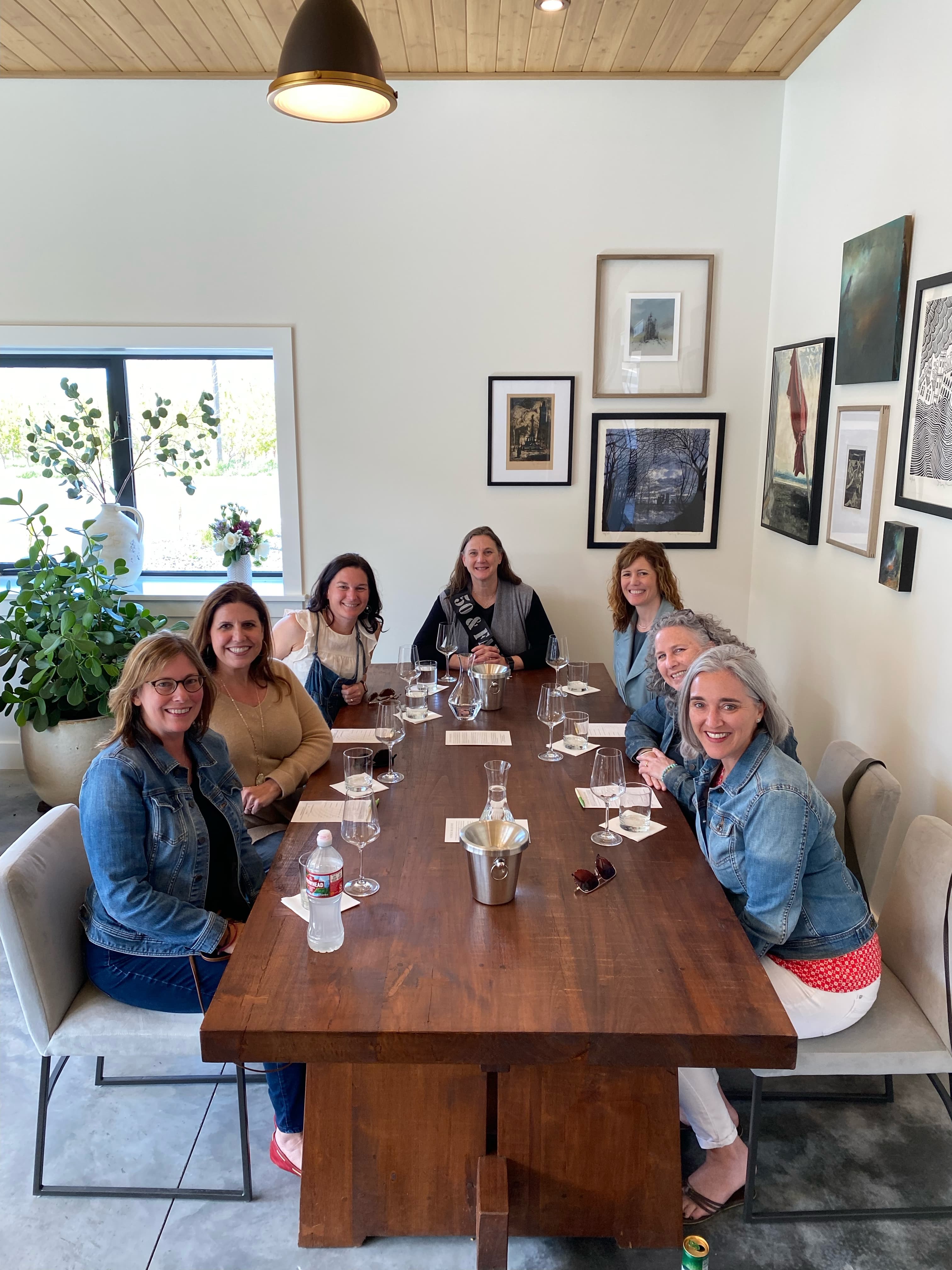 A small group talking with a winemaker in a quiet tasting room